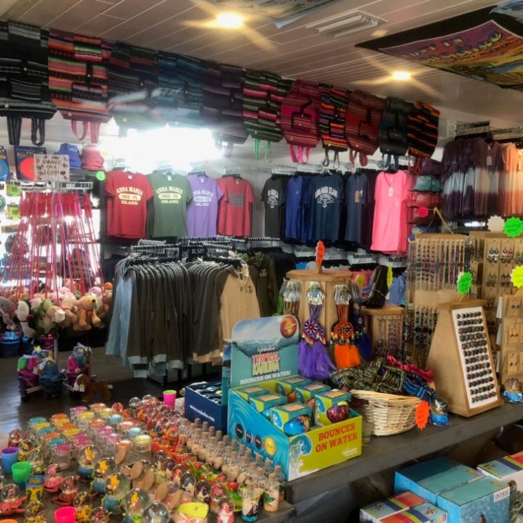 a gift shop with toys, shirts, and bags