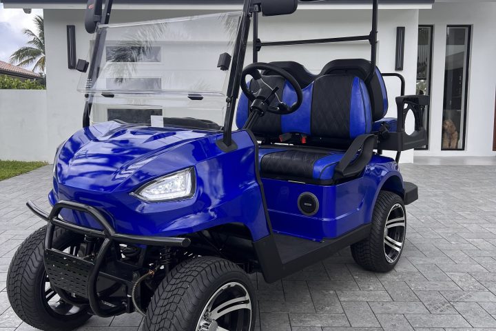 a blue motorcycle parked on the side of a building